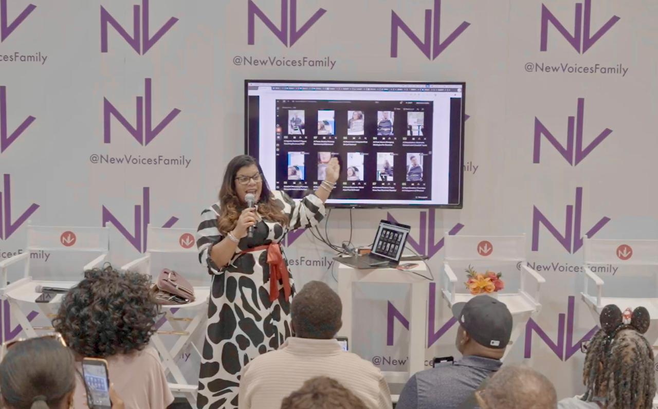 Alicia Lyttle delivers a live demo on AI education for entrepreneurs at ESSENCE Festival, showing practical tools and workflows to an engaged audience.
