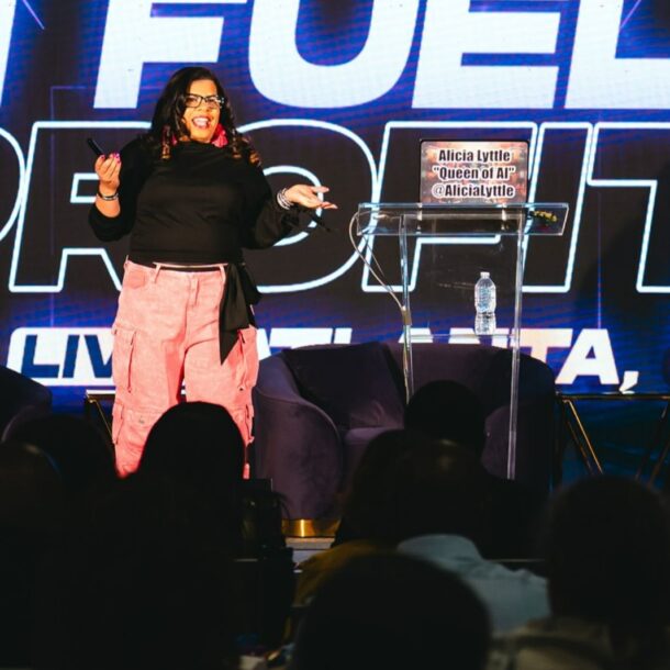 Alicia Lyttle speaking on stage at AI Fueled Profits Live in Atlanta, delivering strategies to entrepreneurs and AI consultants.