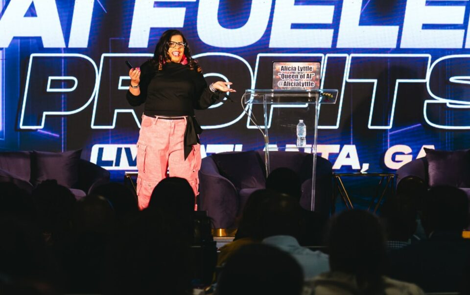Alicia Lyttle speaking on stage at AI Fueled Profits Live in Atlanta, delivering strategies to entrepreneurs and AI consultants.