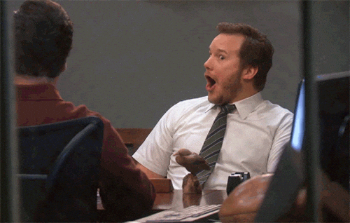 Zoomed-in view of a surprised and happy office worker reacting to the ease of Google Gemini scheduling for team coordination.